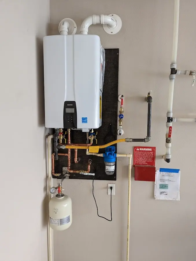 Professional plumber installing copper piping in a McComb home